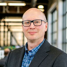 A person poses for a headshot.