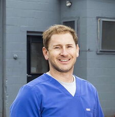 A person poses for a headshot.