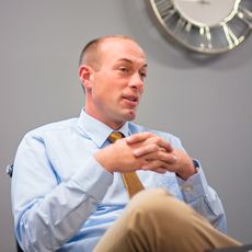 Bryan Thompson sitting in a conference room.