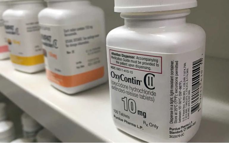 vials of oxycontin pills on a shelf