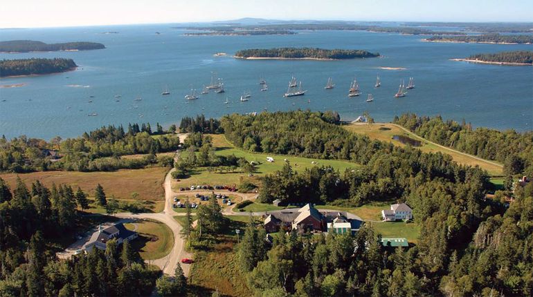 aerial of fields, water and buildings