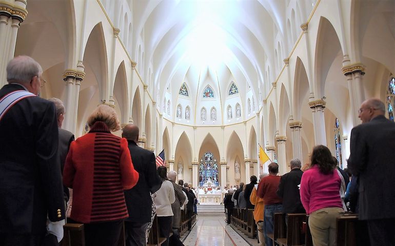 people standing in pews