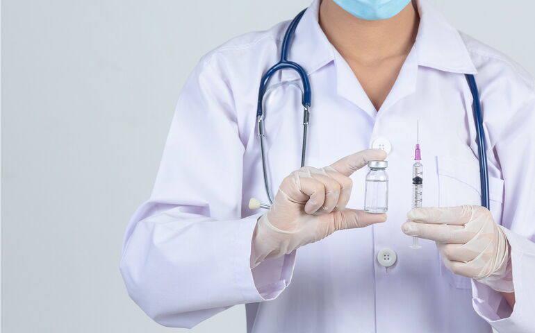 medical professional holding syringe