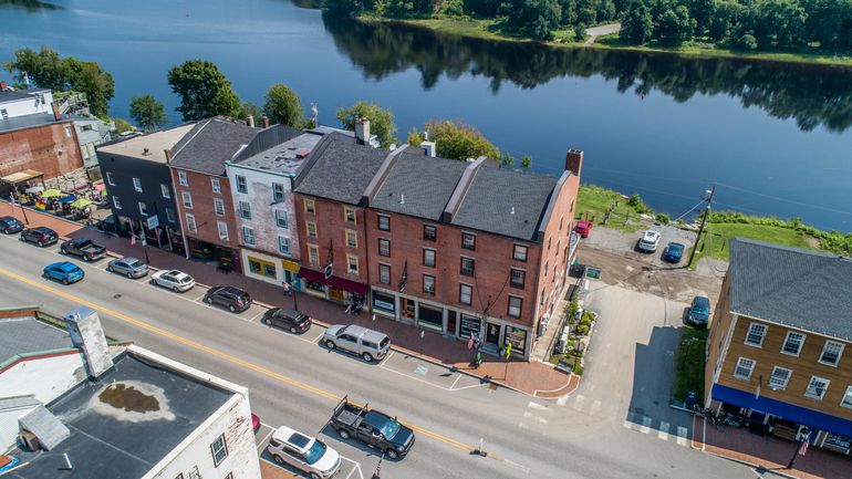 aerial of old brick buildings and river