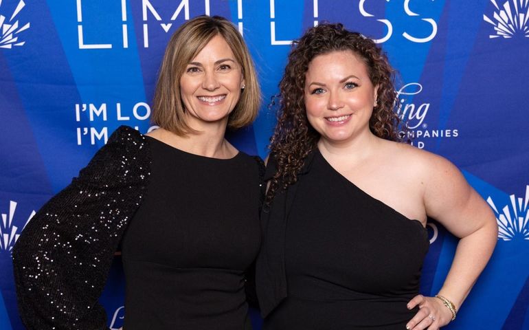 2 people in black clothes smiling