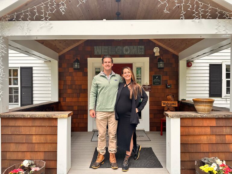 2 people smiling on porch