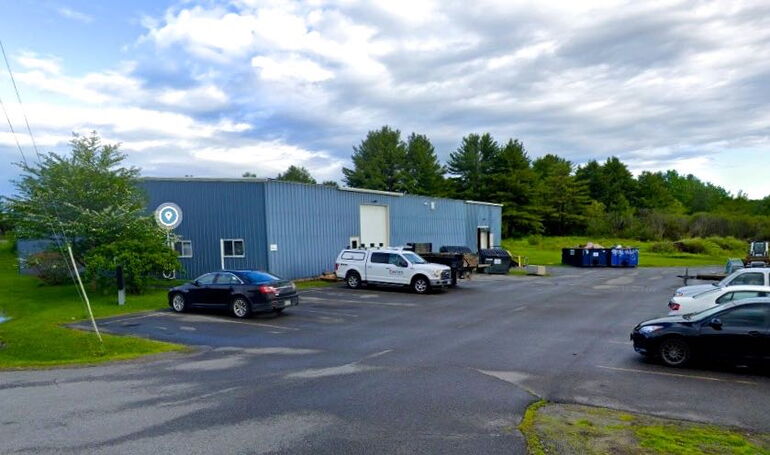 blue metal building and vehicles