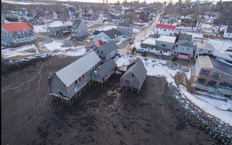 aerial of buildings on a shoreline with mudflats
