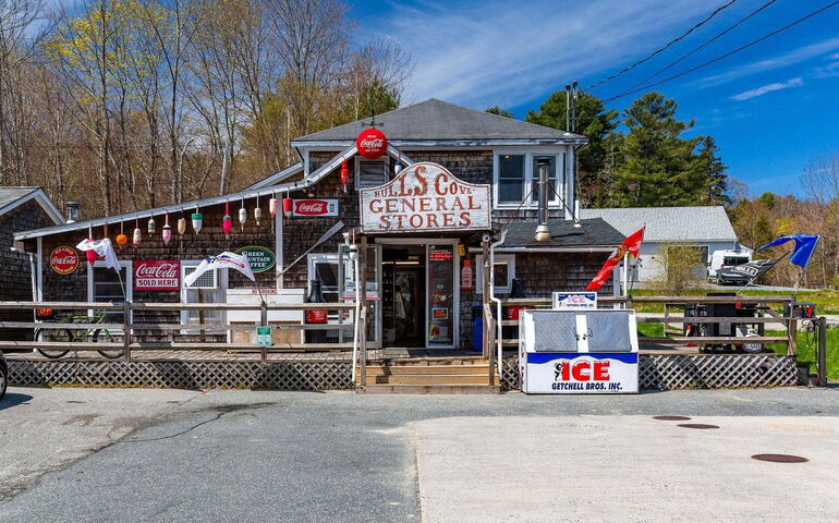 building with funky sign and lobster buoys hanging from roof