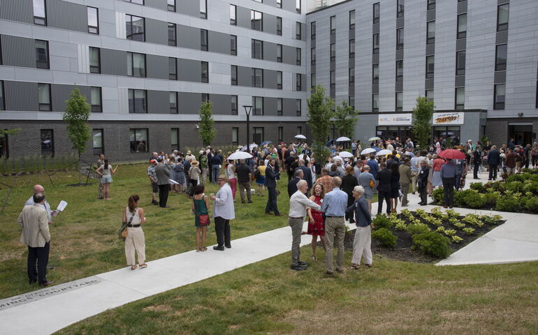 At USM, a group of people stand in a courtyard.