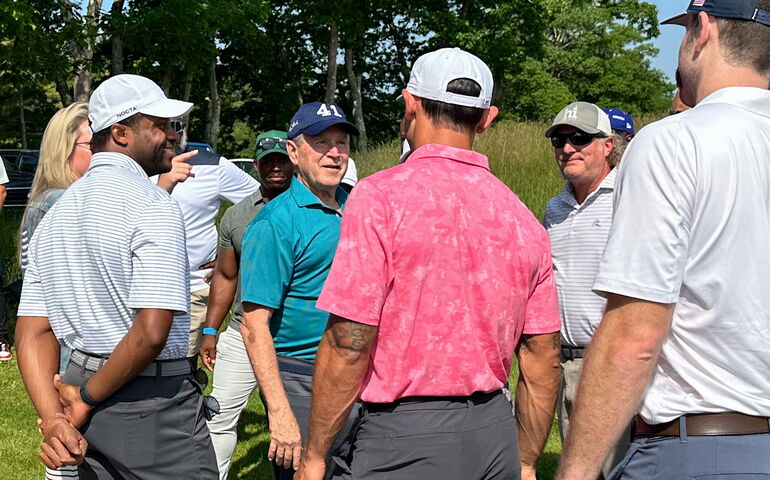 Former U.S. President George W. Bush with golfers.