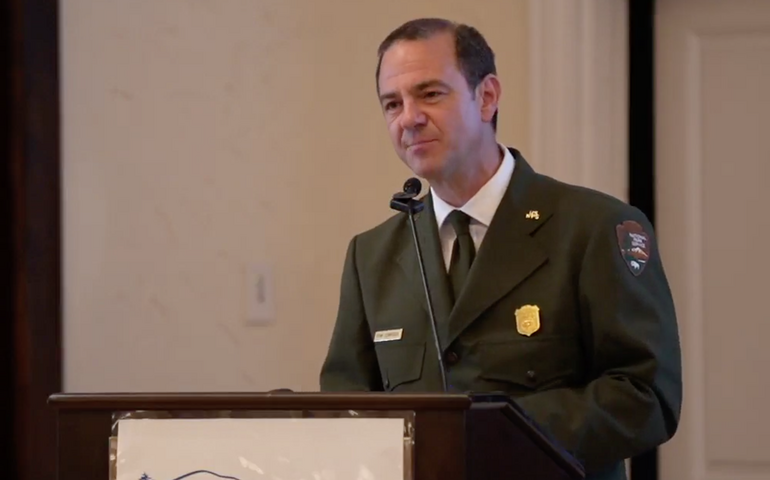 Kevin Schneider of Acadia National Park stands at a podium.