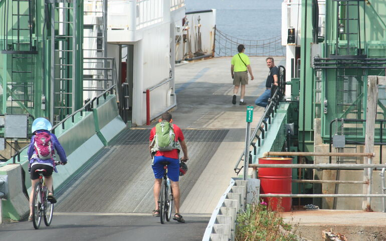 People board a ferry.