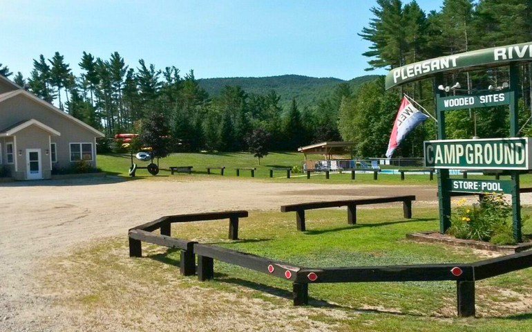 The entrance to the campground has signage and a small building.