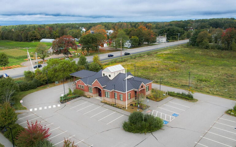 An aerial view shows buildings and grounds.