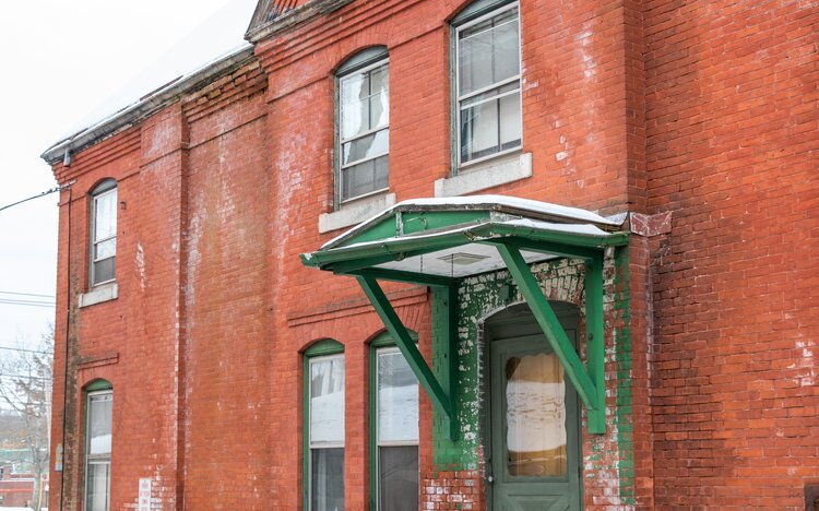 The old jail and home in Ellsworth is seen before the brickwork was restored.