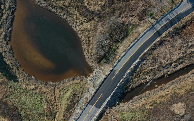 An aerial view of land and road.