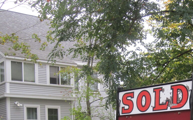 A house and a 'sold' sign.