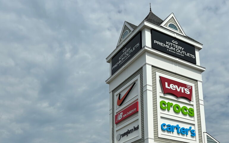 A tower with signs on it at Kittery Premium Outlets.