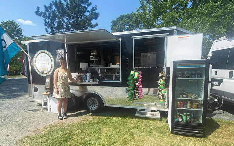 The towner stands outside her mobile bakery.