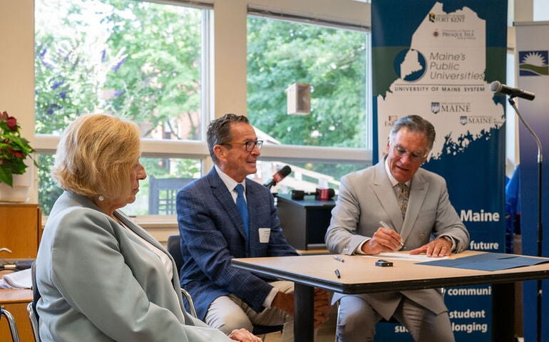 Mills, Malloy and Daigler formalize a transfer agreement.