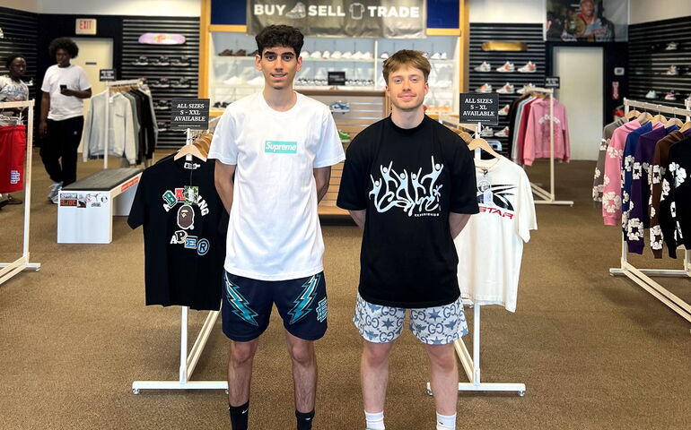 Two people stand in their Kittery retail store.