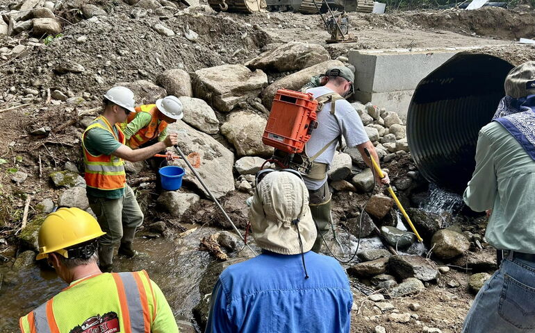 People work on a stream and structure.