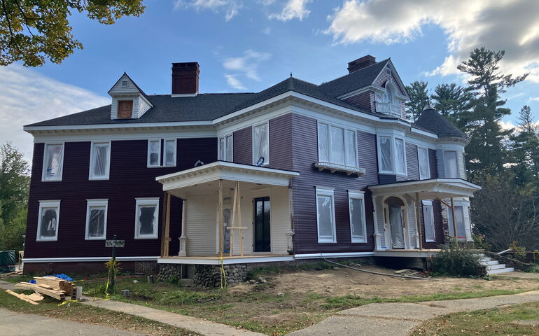 An old house has new brown paint.