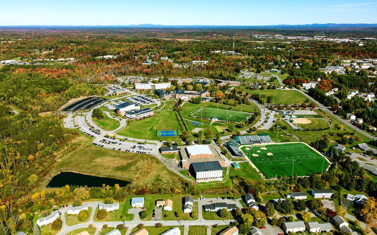 An aerial photo shows the Husson campus.