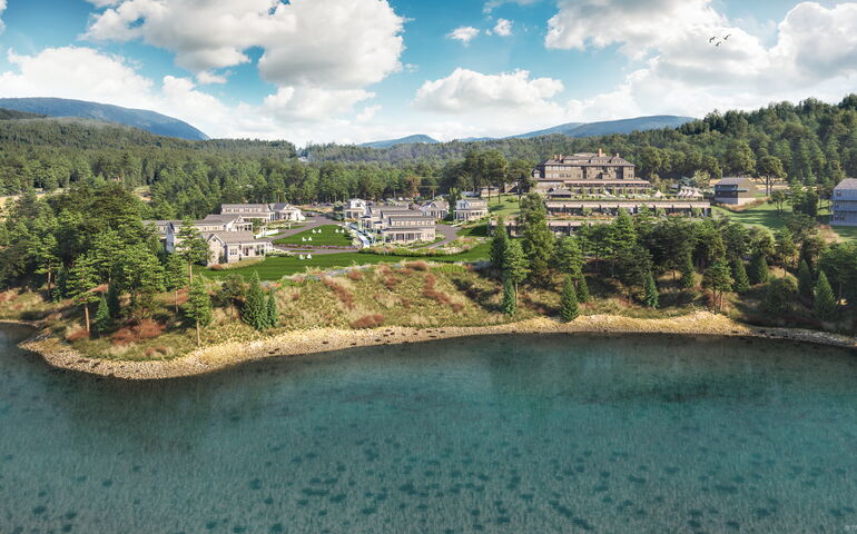 An aerial view of a hotel by the water.