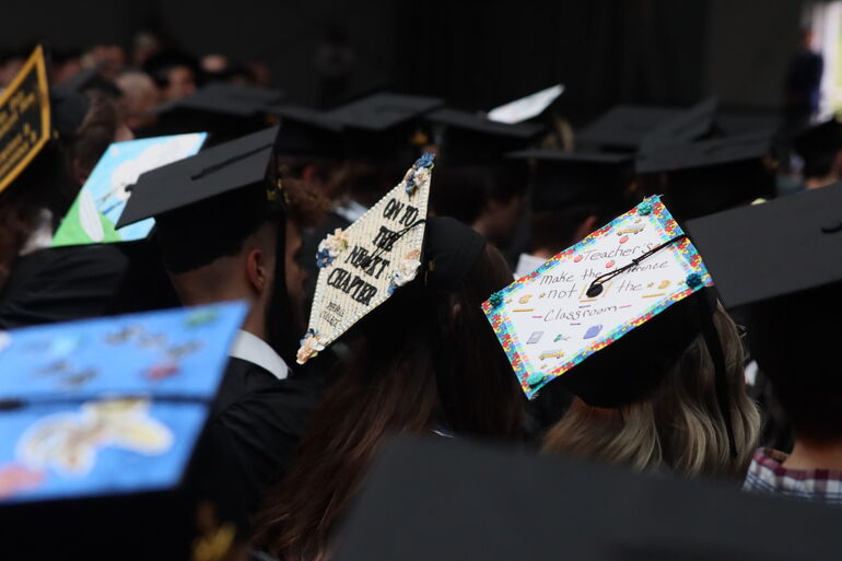 Thomas College graduates caps and gowns 