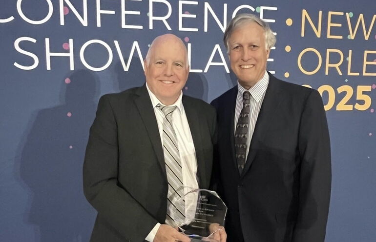 two men holding award